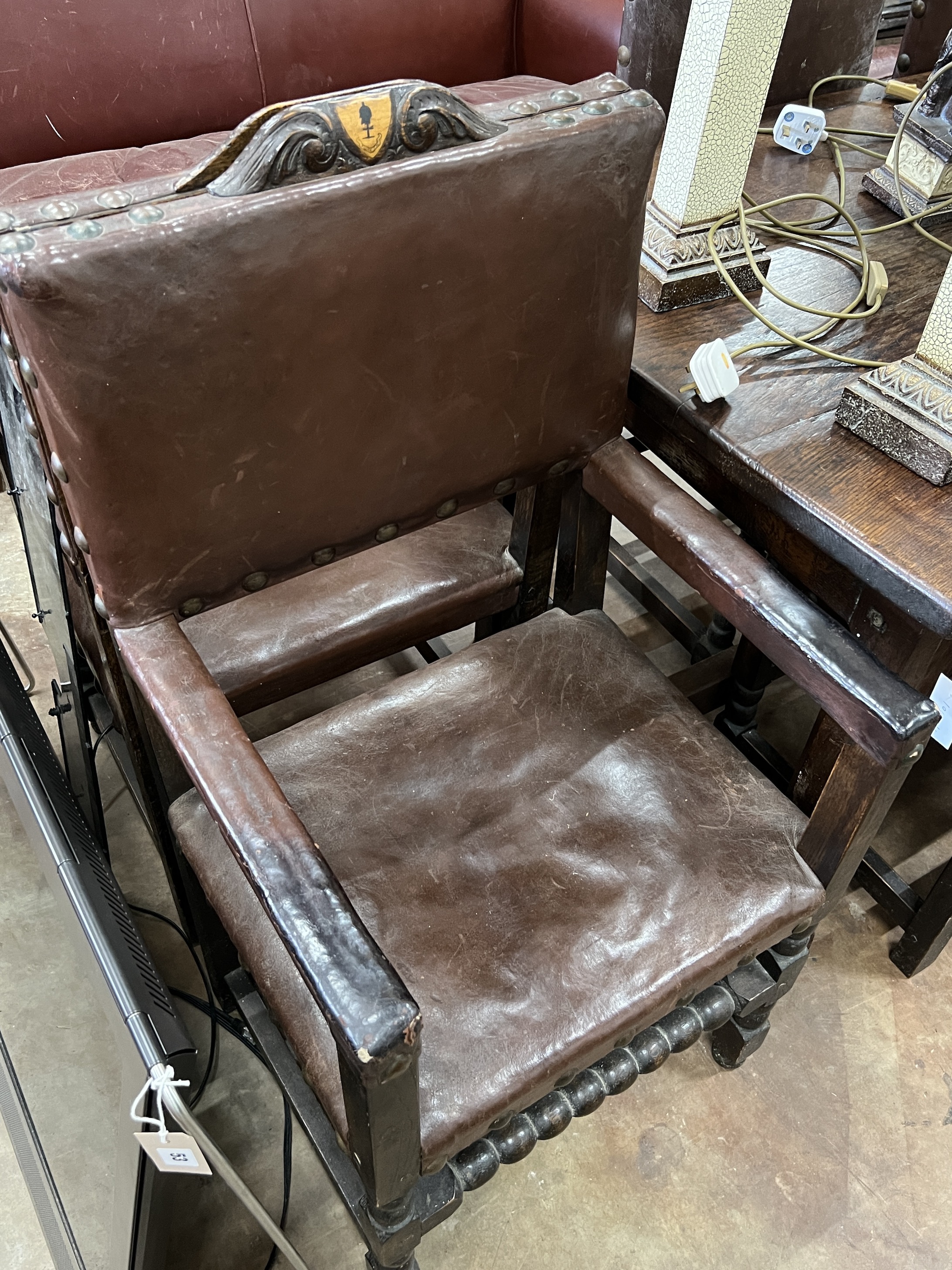 A set of eight 1920’s 17th century style oak dining chairs, the carvers with crested top rails